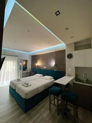 a bedroom with a bed and a kitchen with a sink at Emerald Lux Apartment in Athens
