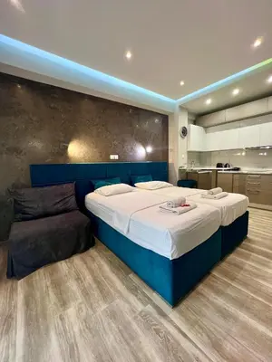 a large bedroom with a large bed and a couch at Emerald Lux Apartment in Athens