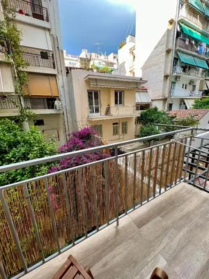 a balcony with a fence and some buildings at Emerald Lux Apartment in Athens