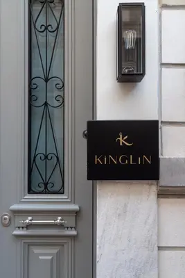 a sign on the side of a building with a door at Kinglin Luxury Living in Athens