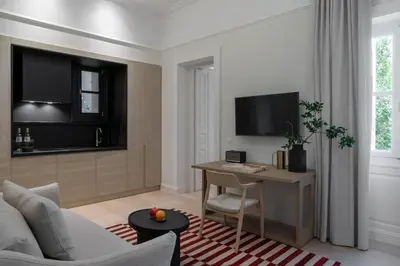 a living room with a couch and a table and a tv at Kinglin Luxury Living in Athens