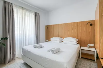 a bedroom with a white bed with two towels on it at Elia Kolonaki Luxury Apartments in Athens