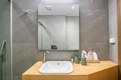 a bathroom with a sink and a mirror at Elia Kolonaki Luxury Apartments in Athens