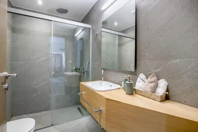 a bathroom with a sink and a shower at Elia Kolonaki Luxury Apartments in Athens