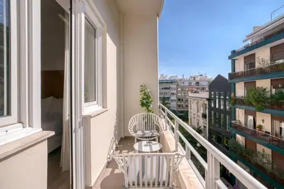 a balcony with a table and chairs on a building at Elia Kolonaki Luxury Apartments in Athens