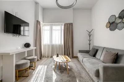a living room with a couch and a table at Elia Kolonaki Luxury Apartments in Athens