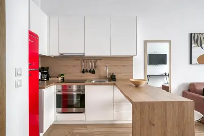 a kitchen with white cabinets and a red refrigerator at Elia Kolonaki Luxury Apartments in Athens