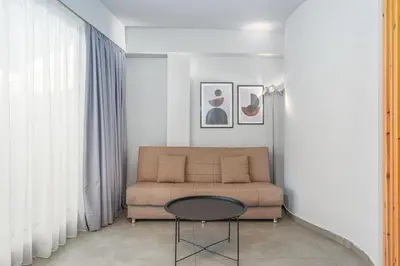 a living room with a couch and a table at IVY Apartments in the Heart of Athens in Athens