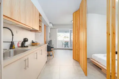 a kitchen with a sink and a bed in a room at IVY Apartments in the Heart of Athens in Athens