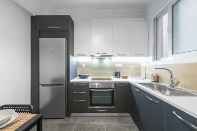 a kitchen with a stainless steel refrigerator and a sink at Athens Central Pangrati - Varnava Square Modern Apartment for 5 in Athens