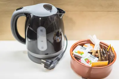 a tea kettle and a basket of food on a counter at Athens Central Pangrati - Varnava Square Modern Apartment for 5 in Athens