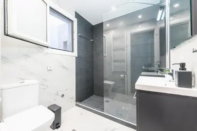a bathroom with a shower and a toilet and a sink at Athens Central Pangrati - Varnava Square Modern Apartment for 5 in Athens