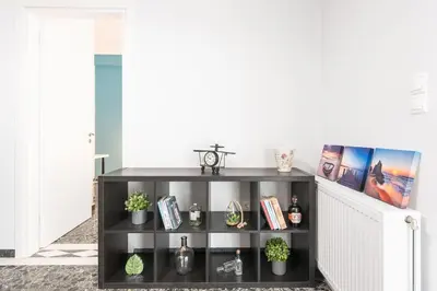 a black book shelf in a living room at Athens Central Pangrati - Varnava Square Modern Apartment for 5 in Athens