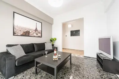a living room with a couch and a tv at Athens Central Pangrati - Varnava Square Modern Apartment for 5 in Athens