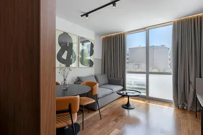 a living room with a couch and a table at The Athenians Art Apartments in Athens