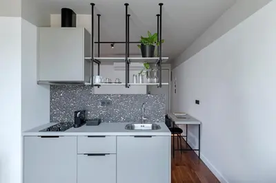 a kitchen with white cabinets and a sink at The Athenians Art Apartments in Athens