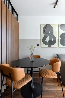 a dining room with a black table and chairs at The Athenians Art Apartments in Athens