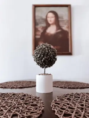 a flower in a white vase on a table at IVY Muse 1BR Apartment in Neos Kosmos Athens in Athens