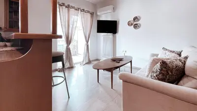 a living room with a couch and a table at IVY Muse 1BR Apartment in Neos Kosmos Athens in Athens