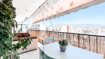 a table and chairs on a balcony with a view at IVY Muse 1BR Apartment in Neos Kosmos Athens in Athens