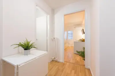 a white hallway with a plant on a white table at Apartment at Megaro Mousikis st semi basement 1bed 2 pers by MPS in Athens