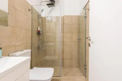 a bathroom with a shower with a toilet and a sink at Apartment at Megaro Mousikis st semi basement 1bed 2 pers by MPS in Athens