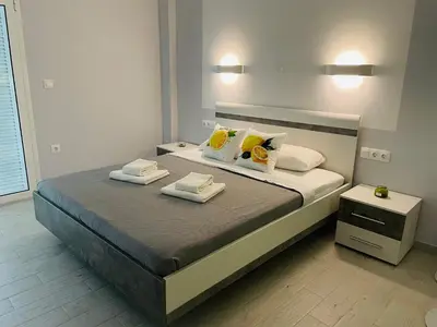 a bedroom with a bed with two towels on it at Lemoni Garden Apartment VIPGreece in Athens