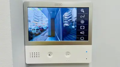 a television on a wall with a picture of a street at Lemoni Garden Apartment VIPGreece in Athens