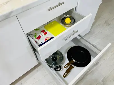 a kitchen drawer with a frying pan and pans in it at Lemoni Garden Apartment VIPGreece in Athens