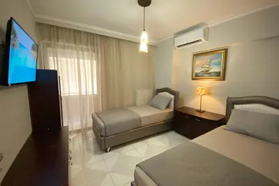 a hotel room with two beds and a flat screen tv at MyAcropolis in Athens