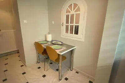 a dining room table with two chairs and a window at MyAcropolis in Athens