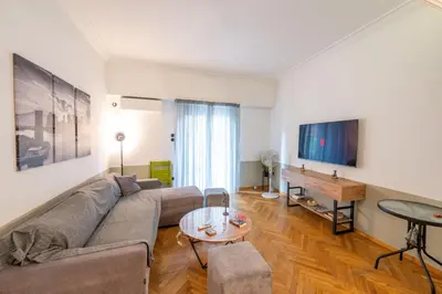 a living room with a couch and a table at Entire Apartment - Heart of Athens in Athens