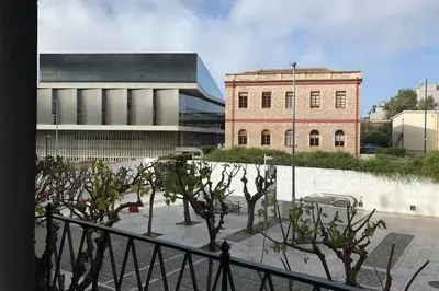 a group of trees in front of a building at Entire Apartment - Heart of Athens in Athens