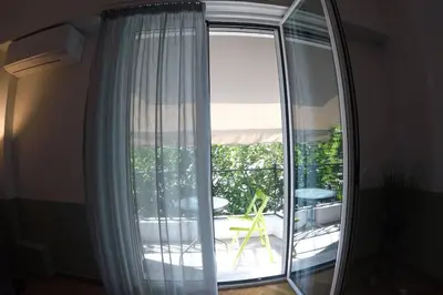 a large glass window with a view of a patio at Entire Apartment - Heart of Athens in Athens