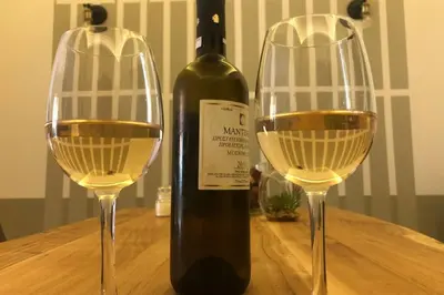 a bottle of wine and two wine glasses on a table at Entire Apartment - Heart of Athens in Athens