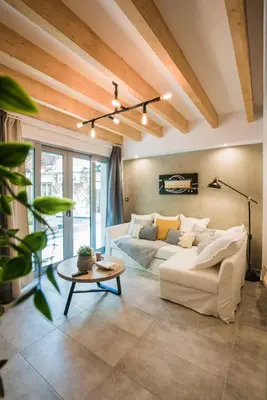 a living room with a white couch and a table at Athenian Living Suites in Athens