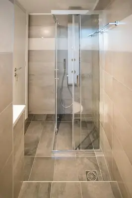 a shower with a glass door in a bathroom at Athenian Living Suites in Athens