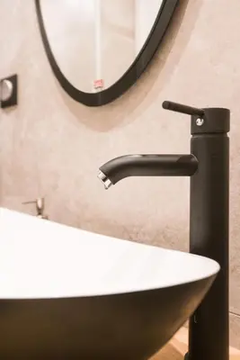 a bathroom with a sink and a mirror at Athenian Living Suites in Athens
