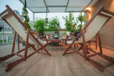 a couple of chairs sitting on a balcony at Athenian Living Suites in Athens
