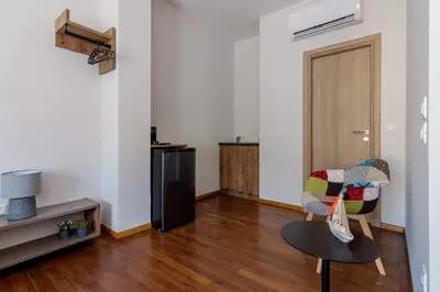 a living room with a table and a chair at 105 Adrianou Plaka in Athens