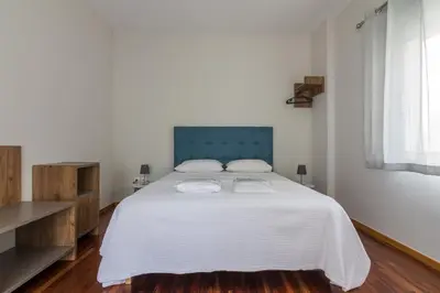 a bedroom with a large white bed with two pillows at 105 Adrianou Plaka in Athens