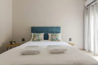 a bedroom with a large white bed with two pillows at 105 Adrianou Plaka in Athens