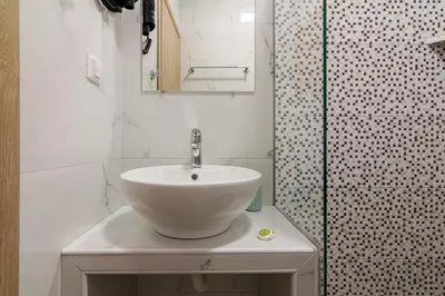 a bathroom with a white sink and a shower at 105 Adrianou Plaka in Athens