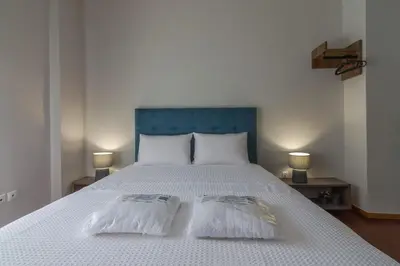 a bedroom with a bed with two pillows on it at 105 Adrianou Plaka in Athens