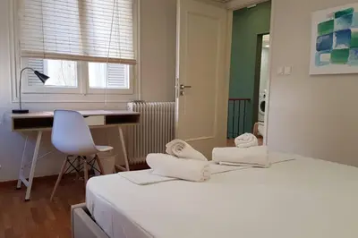 a bedroom with a bed and a desk and a chair at Double Apartment - Athens Center, 7 BD, 3 BATH in Athens