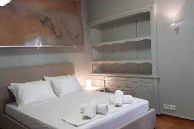 a bedroom with a large white bed with towels on it at Double Apartment - Athens Center, 7 BD, 3 BATH in Athens