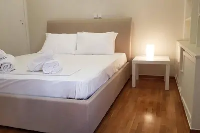 a bedroom with a bed with a candle on it at Double Apartment - Athens Center, 7 BD, 3 BATH in Athens