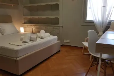 a bedroom with a bed and a table and a desk at Double Apartment - Athens Center, 7 BD, 3 BATH in Athens