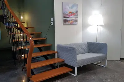 a stairway with a chair next to a stair case at Double Apartment - Athens Center, 7 BD, 3 BATH in Athens
