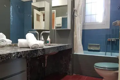 a bathroom with a sink and a toilet at Double Apartment - Athens Center, 7 BD, 3 BATH in Athens